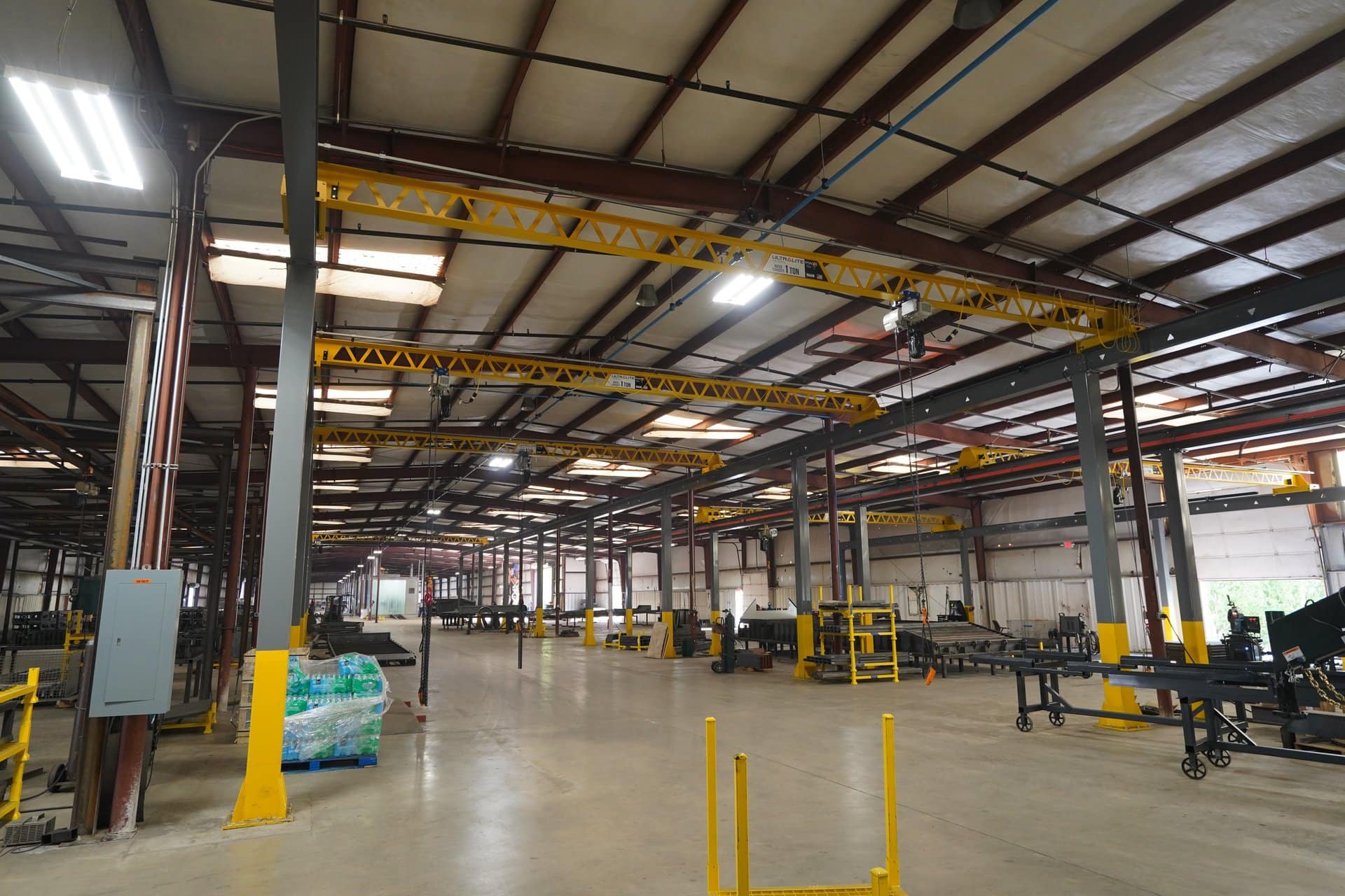 Manufacturing plant with multiple bridge cranes